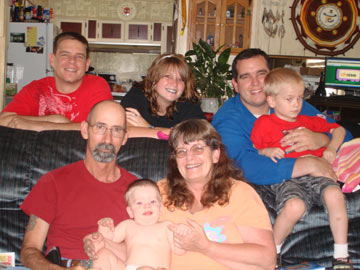 Back Row:Brandon, Mattie, Jeremy holding Tharin.  Front:  Otto, Sue holding Myles on Sue's  55th Birthday...She doesn't look a day over 35.